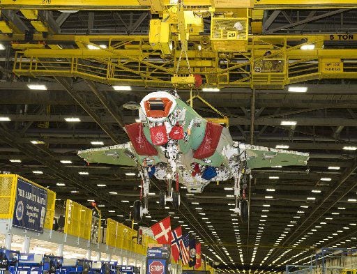 An F-35 fighter jet is moved on the assembly line at the Lockheed Martin facility in Fort...