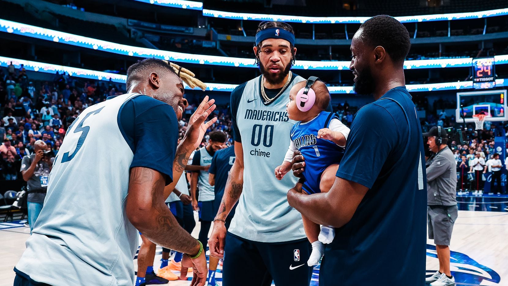 Reggie Bullock and JaVale McGee interact with Theo Pinson's daughter, Alana, during the...
