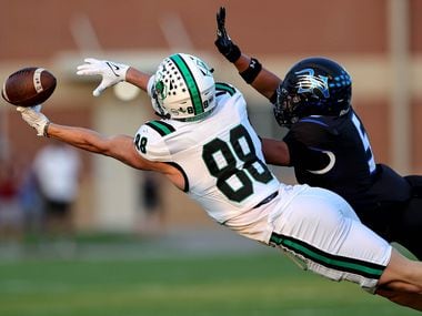 Southlake Carroll tight end Jack Van Dorselaer (88) tries to come up with a reception...