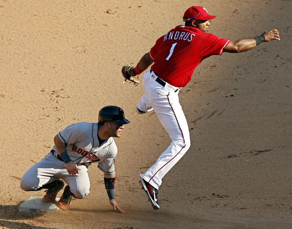 Texas Rangers shortstop Elvis Andrus (1) hops over Houston Astros second baseman Jose Altuve...