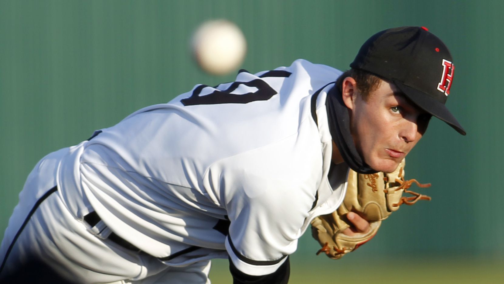 Rockwall Heath pitcher Jonny Lowe (19) watches the path of a fastball as he delivered a...