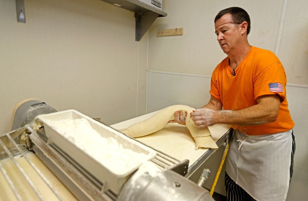 Head baker Chris Cutshall works on dough to make apple cinnamon walnut bread at Empire Bread...