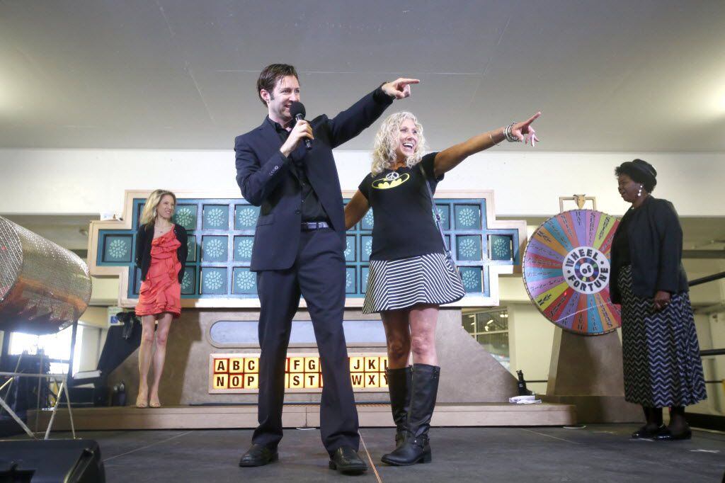 Traveling host Marty Lublin hangs out onstage with Angie Lewis during "Wheel of Fortune"...