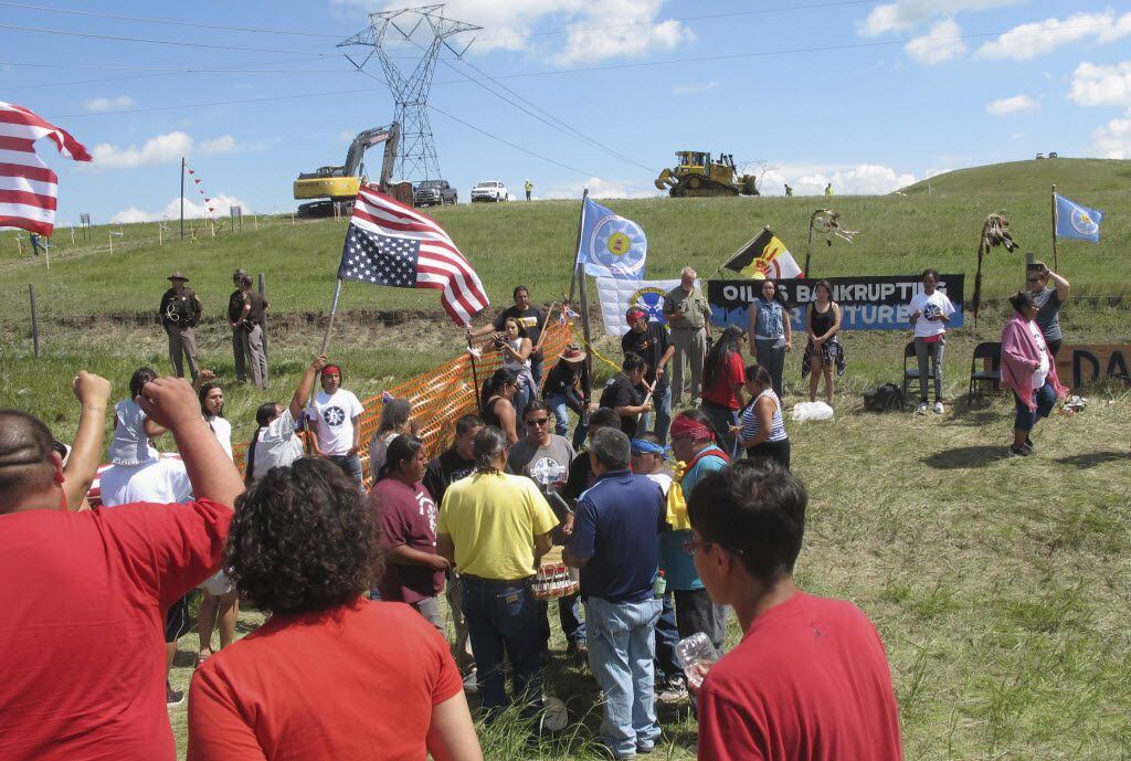 FILE - In this Aug. 12, 2016, file photo, Native Americans protest the Dakota Access oil...
