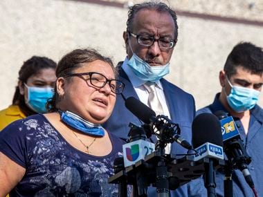 Blanca Parra Gonzalez (center left), the partner of Hugo Dominguez, speaks out about Hugo's death due to COVID-19 at a press conference at the Quality Sausage Company in Dallas on Tuesday, April 28, 2020. Parra Gonzalez is upset that the Quality Sausage Company encouraged workers, including Dominguez, to keep working throughout the coronavirus pandemic.