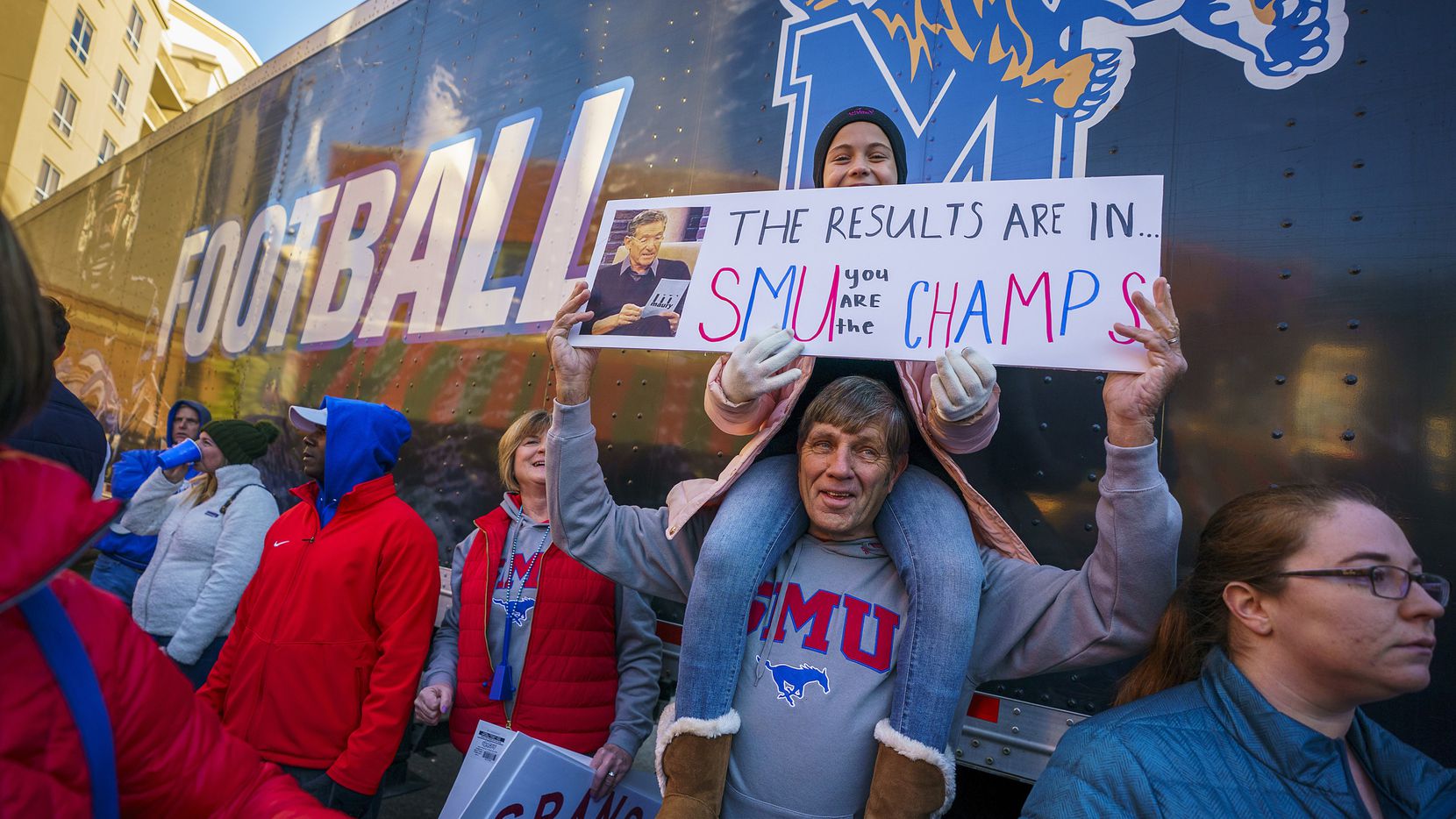 Ellie Granson, younger sister of SMU tight end Kylen Granson, holds a sign atop the shoulders of her uncle Bob Groen during ESPN College GameDay on Beale Street before an NCAA football game  on Saturday, Nov. 2, 2019, in Memphis, Tenn. 