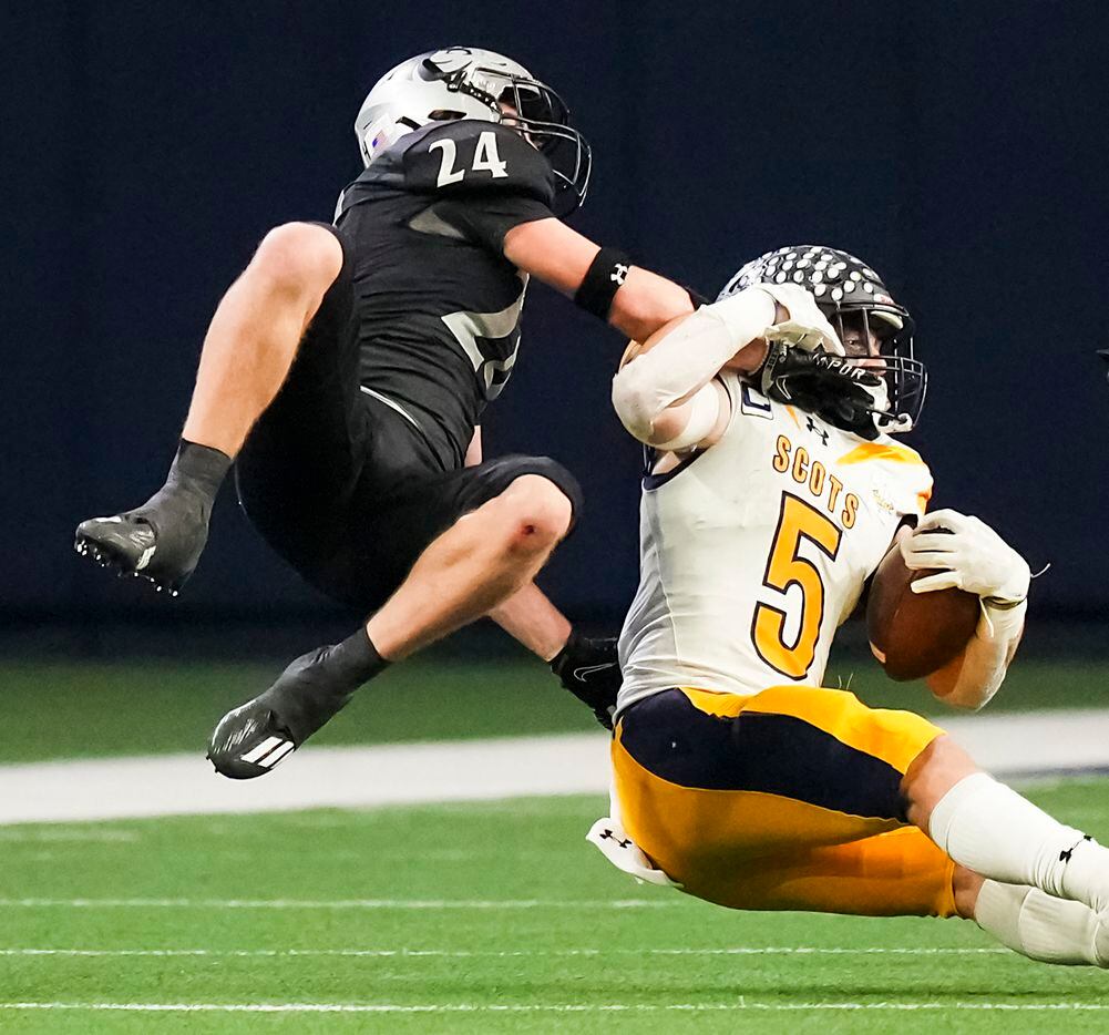 Highland Park running back Jay Cox (5) is brought down by Denton Guyer defensive back Caleb...
