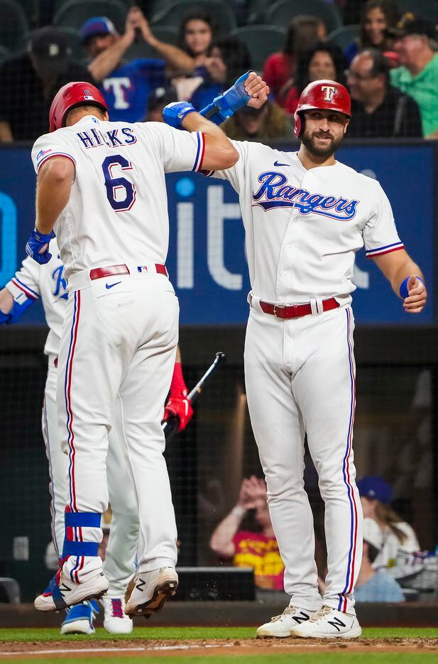 Texas Rangers catcher John Hicks celebrates with right fielder Joey Gallo after hitting a...