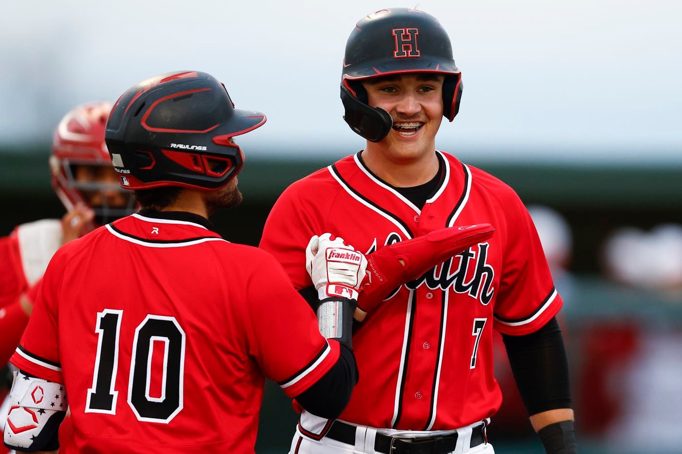 Rockwall-Heath’s Caleb Hoover (7) is congratulated by Run Butler (10) after scoring a run on...