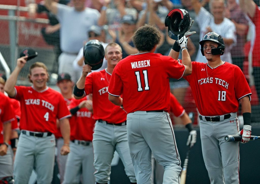 Texas Tech's Cameron Warren (11) high-fives Cole Stilwell (18) after hitting a home run against Dallas Baptist during the NCAA college baseball regional tournament, Saturday, June 1, 2019, in Lubbock, Texas. (Brad Tollefson/Lubbock Avalanche-Journal via AP)