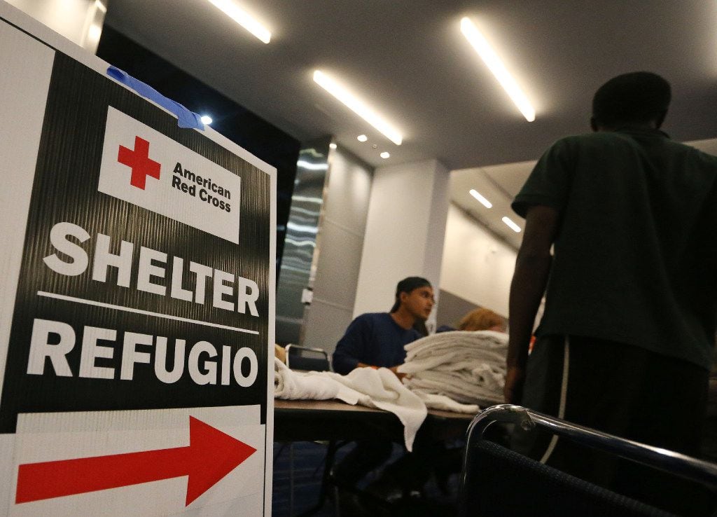 Signs show the way for the Red Cross shelter at the George Brown Convention Center in  Houston on Monday, August 28, 2017. (Louis DeLuca/The Dallas Morning News)