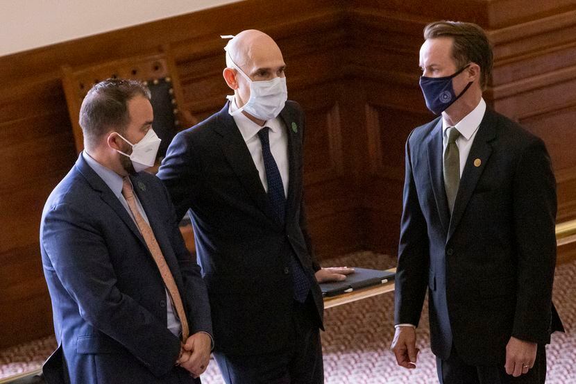 House Speaker Dade Phelan (right) speaks with Reps. Joe Moody (left) and Greg Bonnen in the...