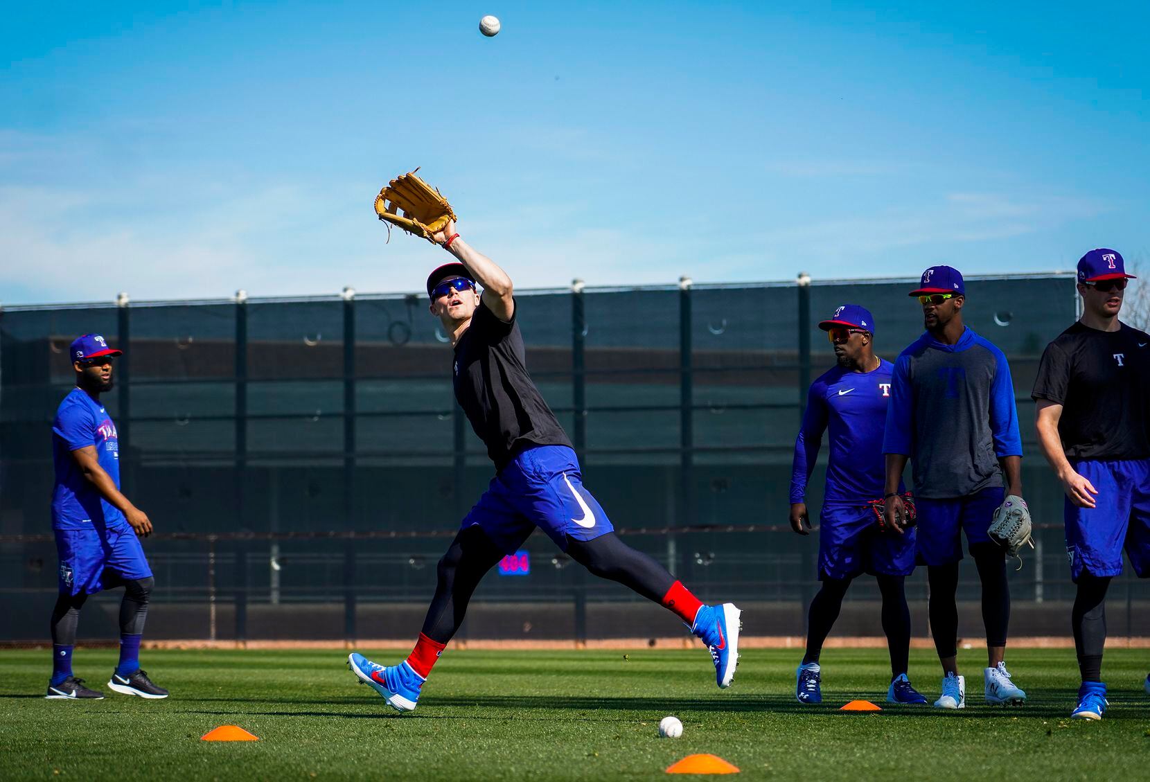 Texas Rangers outfielder Scott Heineman makes a catch while participating in a fielding...