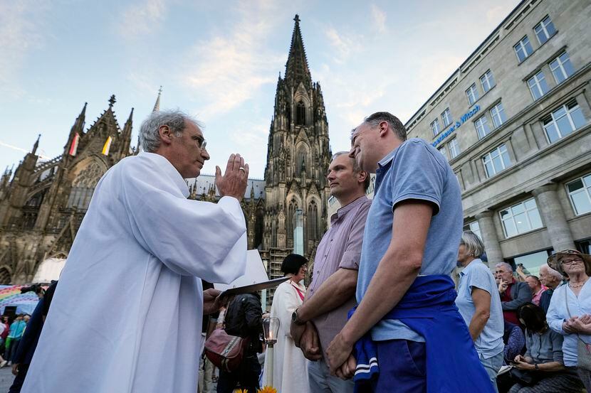 Same-sex couples take part in a public blessing ceremony in front of the Cologne Cathedral...