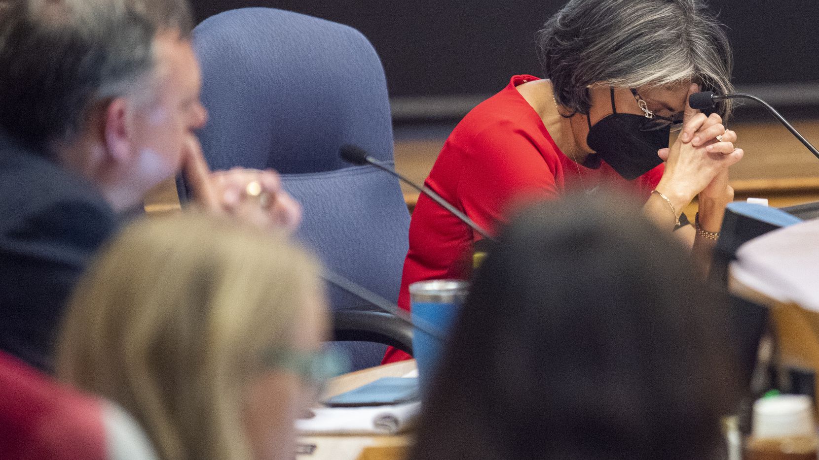 Debbie Rentería, Richardson ISD board member, lowers her head as she reacts to the...