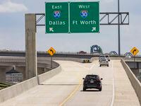 Drivers take the new flyover ramps east and westbound onto I-30 from Highway 360 south near...