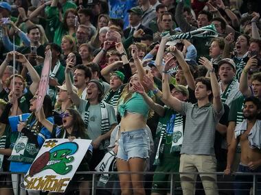 Tulane fans celebrate after a replay review gave tight end Alex Bauman a 6-yard touchdown...
