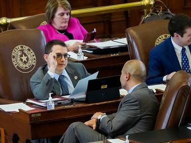 Rep. Briscoe Cain, R-Deer Park, (with glasses) talks with Rep. Cody Harris, R-Hillsboro while democrats speak against SB-7 in the House Chamber at the Texas Capitol during the 87th Texas legislature on Friday, May 7, 2021, in Austin. (Smiley N. Pool/The Dallas Morning News)