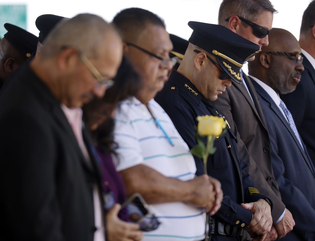 Dallas police chief Eddie Garcia (third from right) joined fellow officers and Zamarripa family members in prayer during the annual Police Memorial Day in which the Department honored officers who died in the line of duty at the Dallas Police Memorial in downtown Dallas, Wednesday, July 7, 2021.  Zamarripa was one of the officers remembered on the 5th anniversary of the July 7th ambush. (Tom Fox/The Dallas Morning News)