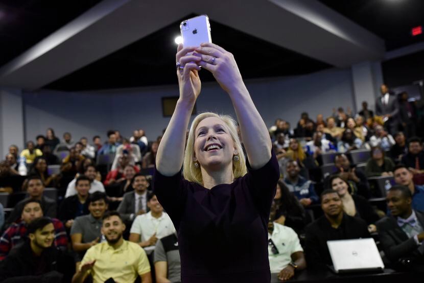 Senator Kirsten Gillibrand holds her phone as she takes a selfie video with students from...