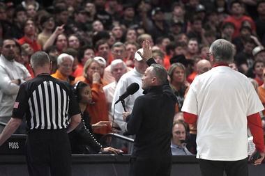 Texas Tech's head coach Grant McCasland, center, speaks to fans after objects were thrown on...