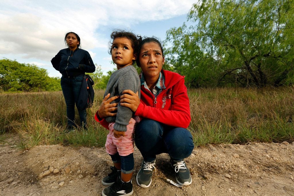 Lirio Funes, 20, holds onto her daughter Melissa Funes, 2, just after being detained by...