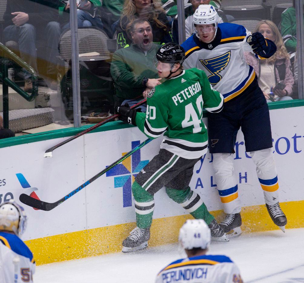A fan reacts to Dallas Stars center Jacob Peterson (40) and St. Louis Blues defenseman Niko Mikkola (77) hitting the plexiglass during the third period of a Dallas Stars preseason game against St. Louis Blues on Tuesday, Oct. 5, 2021, at American Airlines Center in Dallas. (Juan Figueroa/The Dallas Morning News)