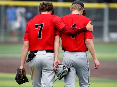 Martin third baseman Max Grubbs (7) consoles pitcher Luke Spencer(1) after he was replaced...