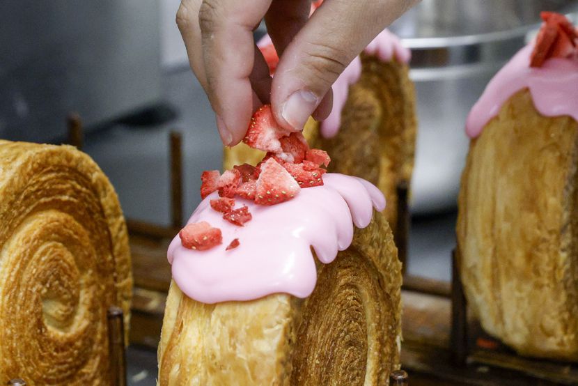 La 57 founder Laura Macarena places strawberries atop a supreme croissant at La 57,...