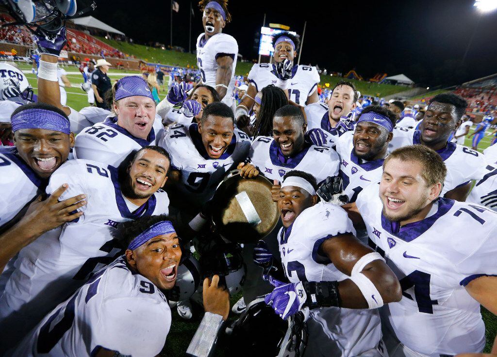 TCU Horned Frogs football players try to get into a group photo as they show off the Iron...