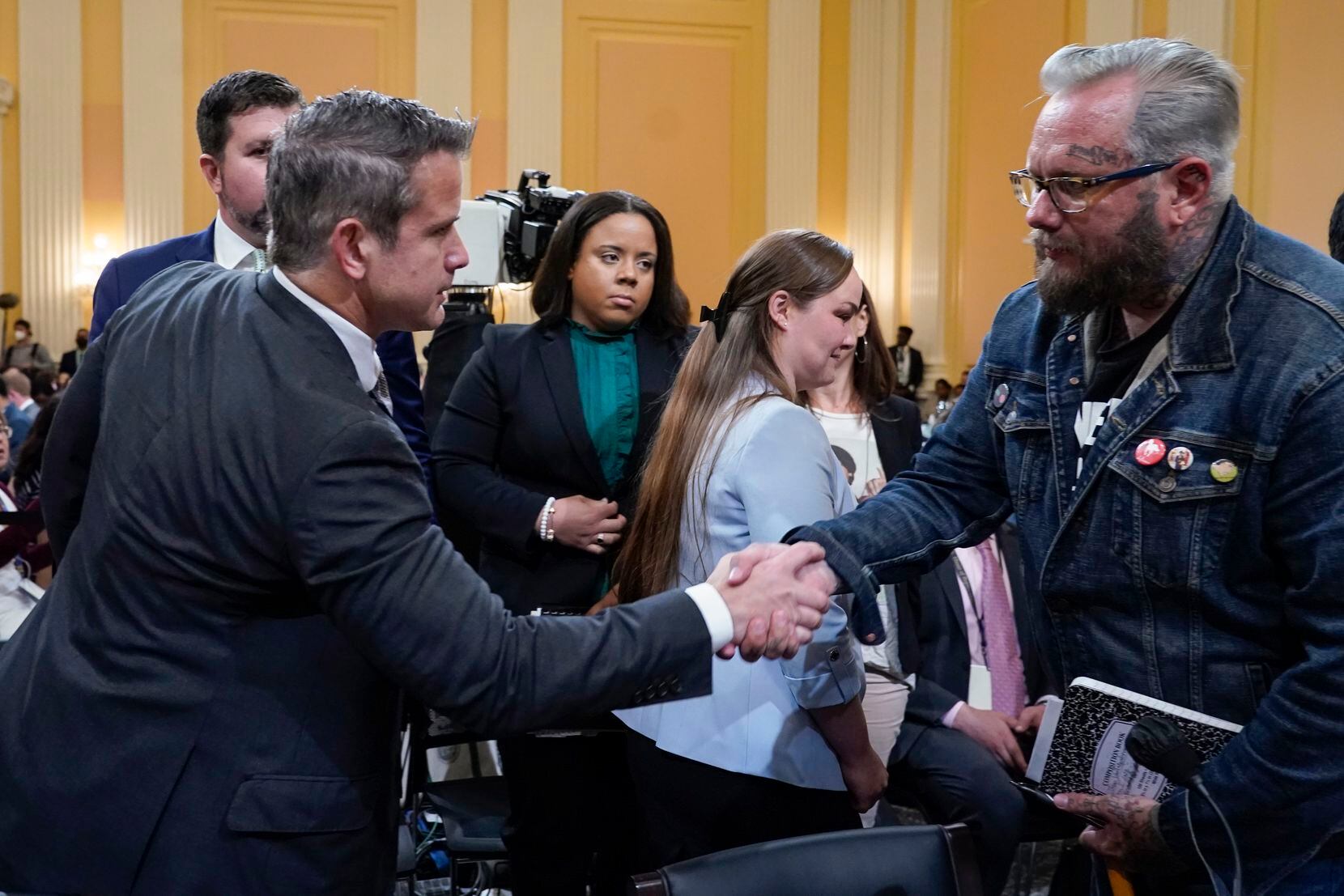 Rep. Adam Kinzinger, R-Ill., shakes hands with Jason Van Tatenhove, an ally of Oath Keepers...