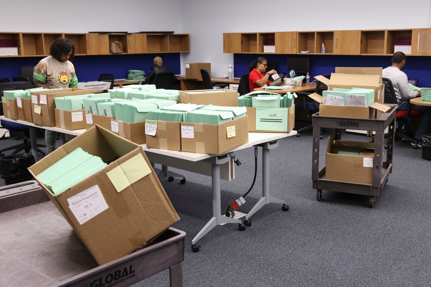 Workers put together mail ballots, Thursday, Oct. 6, 2022 at Dallas County Election Center...