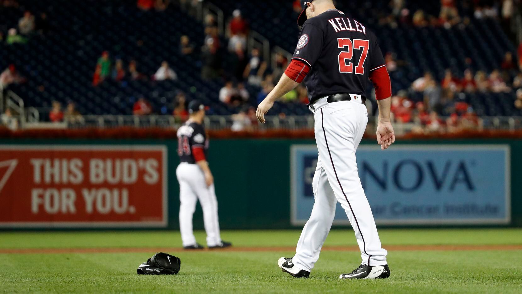 Washington Nationals relief pitcher Shawn Kelley (27) walks to pick up his glove after...