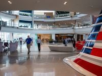 Employees walk through the main lobby of the Skyview 8 building at the American Airlines...
