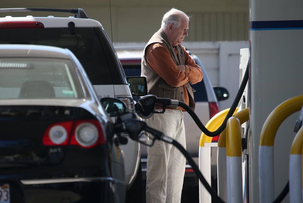 A customer pumps gasoline into his car