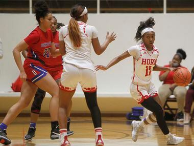 Mesquite Horn guard Asiya Sabr (11) weaves through traffic as she sets up an offensive play...