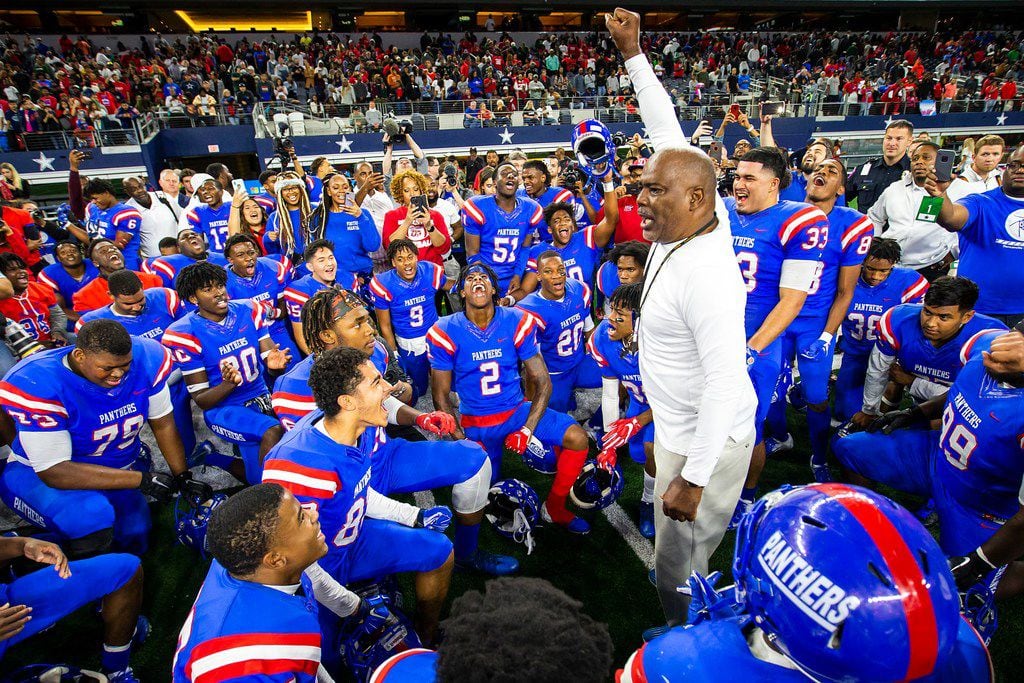 Duncanville players circle around head coach Reginald Samples after a 44-35 victory over...