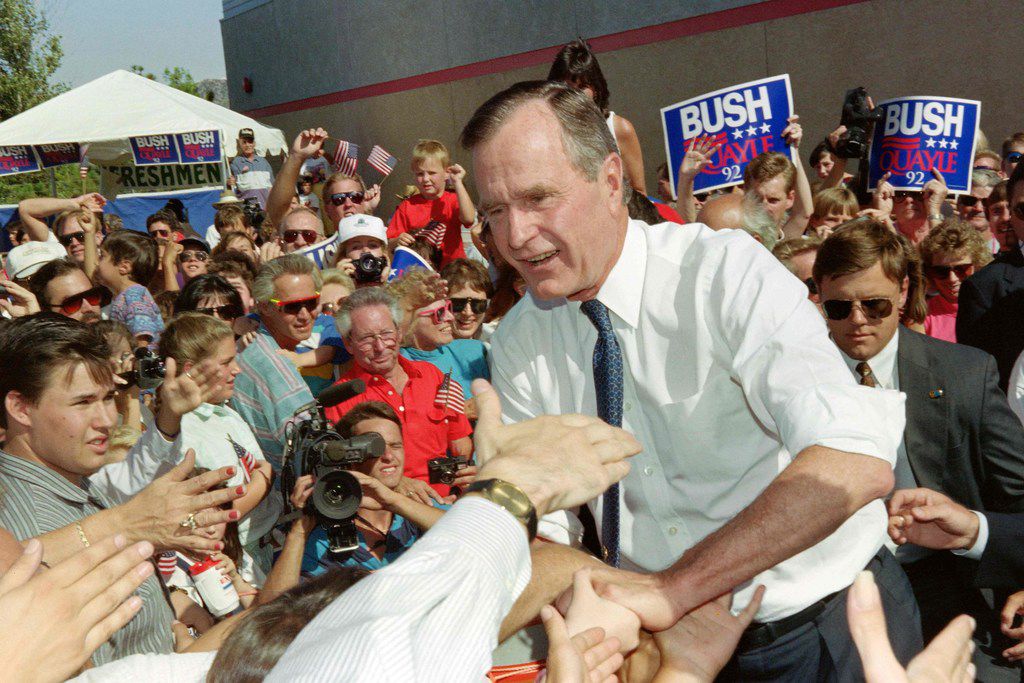 (FILES) In this file photo taken on August 05, 1992 US President George Bush shakes hands...