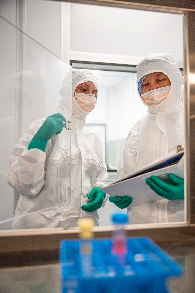 Researchers at Baylor Scott & White Health wearing masks, gloves, and hazard suits while...