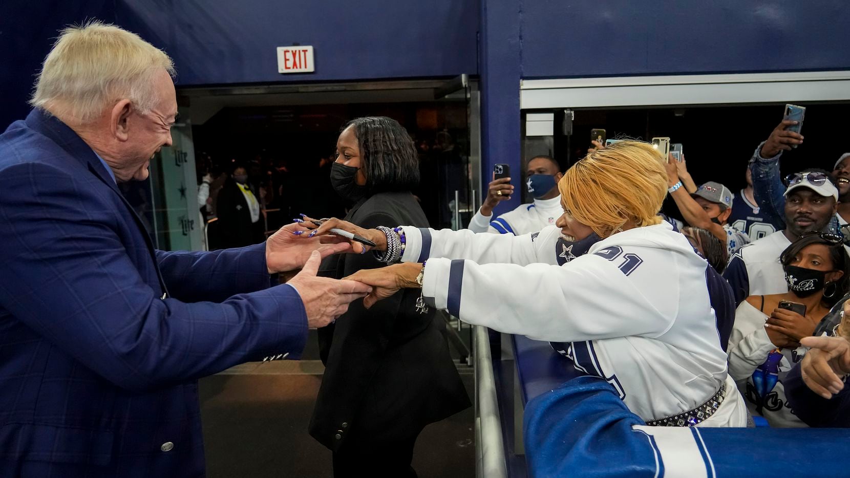 Dallas Cowboys owner and general manager Jerry Jones reaches out to fan Carolyn Price before...