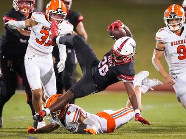 Rockwall-Heath running back  Zach Evans (26) is knocked off his feet by Rockwall defensive...