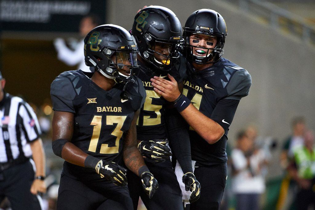 WACO, TX - SEPTEMBER 23:  Denzel Mims #15 of the Baylor Bears celebrates after scoring a touchdown with teammates Tony Nicholson #13 and Zach Smith #11 against the Oklahoma Sooners during the second half at McLane Stadium on September 23, 2017 in Waco, Texas.  (Photo by Cooper Neill/Getty Images)
