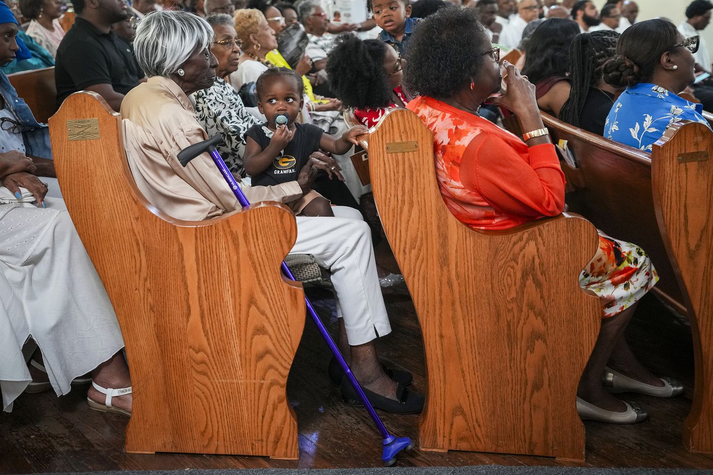 Eli Boyd, 1, sits in the lap of his great grandmother Willie Thompson, 95, during a special...