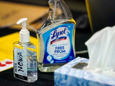 Bottles of hand sanitizer and disinfectant rest on a scorers table during the NCWA national...