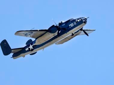 A B-25 Mitchell bomber made several passes over training camp practice in Oxnard,...