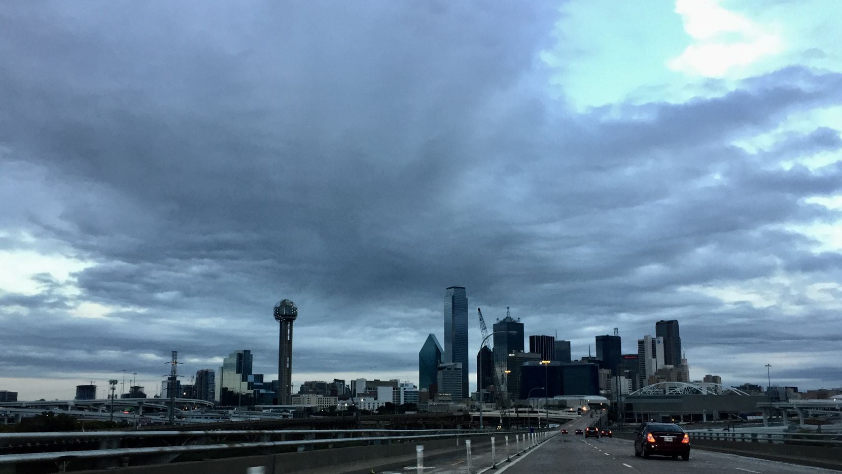 Dark clouds loom over downtown Dallas as a cold front moves in Friday morning. 