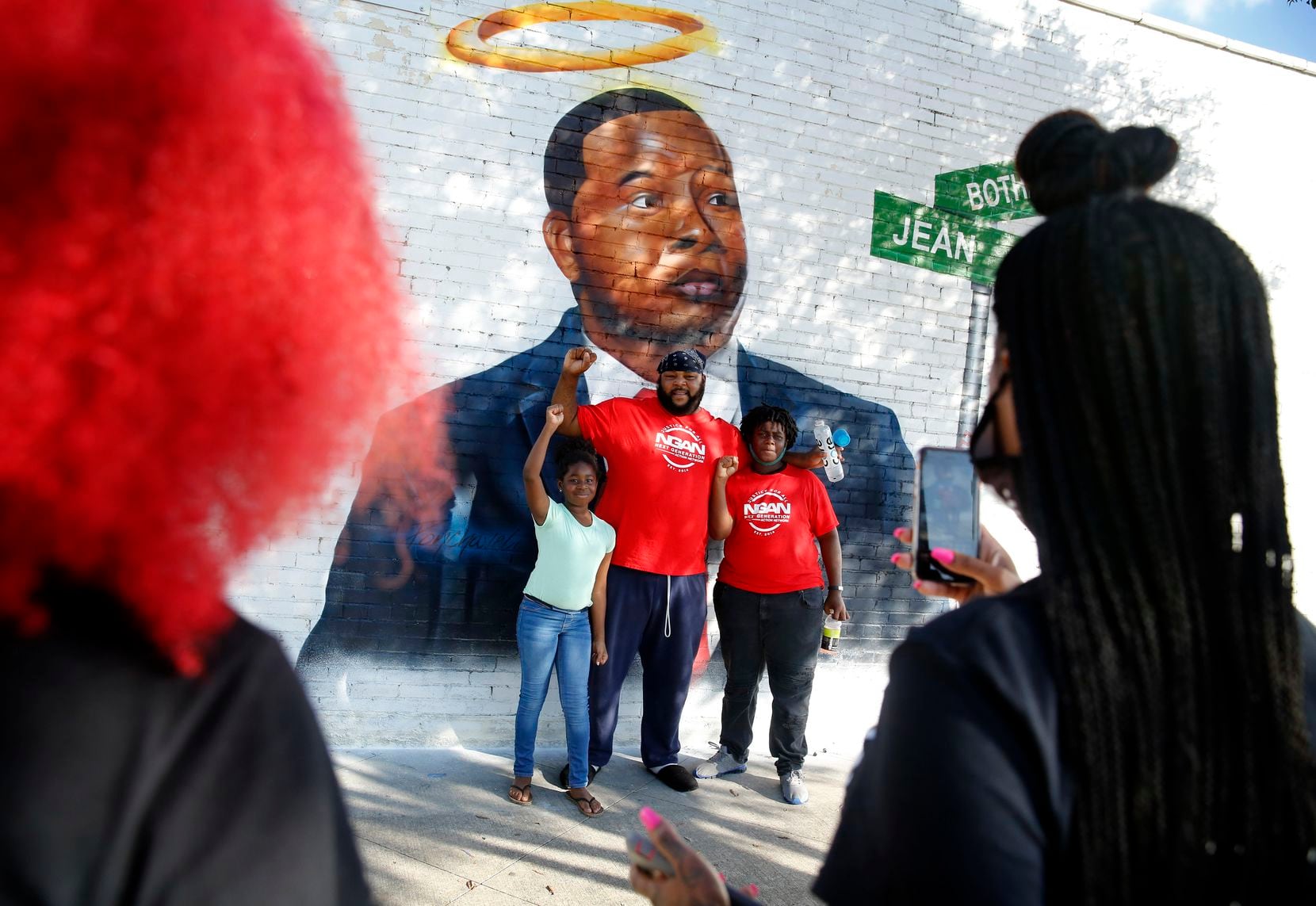 In front of a new painted mural of Botham Jean, Frisco Jackson of Dallas posed for a photo with his son Leo and daughter Aireyin before a memorial gathering on South Lamar at Cadiz Street near downtown Dallas, Sunday, September 6, 2020. Sunday was the second anniversary of Jean's death. Jean was shot and killed in his apartment a few blocks away by former Dallas police officer Amber Guyger. (Tom Fox/The Dallas Morning News)