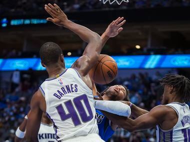 Dallas Mavericks guard Jalen Brunson (13) is tied up by Sacramento Kings guard Davion...