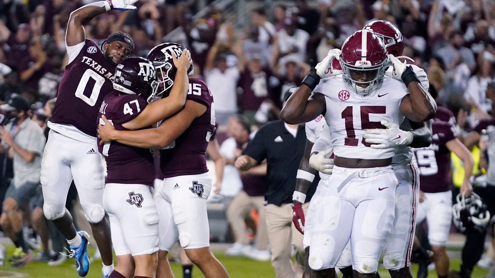Texas A&M's Seth Small (47) celebrates with Nik Constantinou (95) and Ainias Smith (0) after...