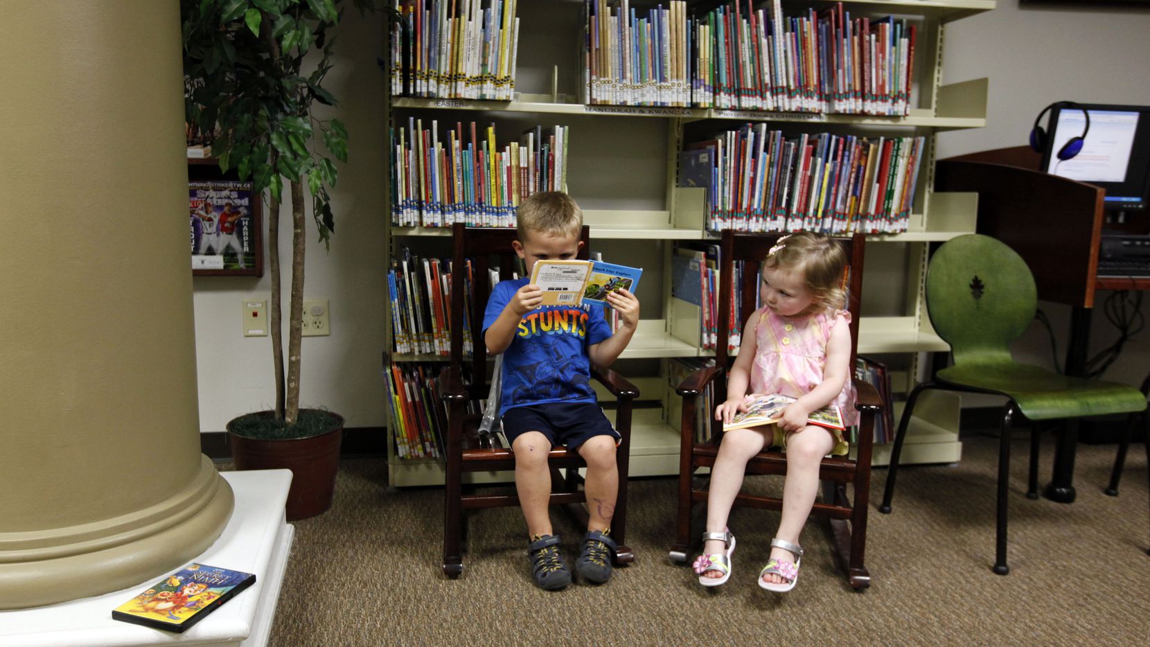 Wes Schug, 2, and Aubrey Hill, 2, read together at the Southlake Public Library on Main...